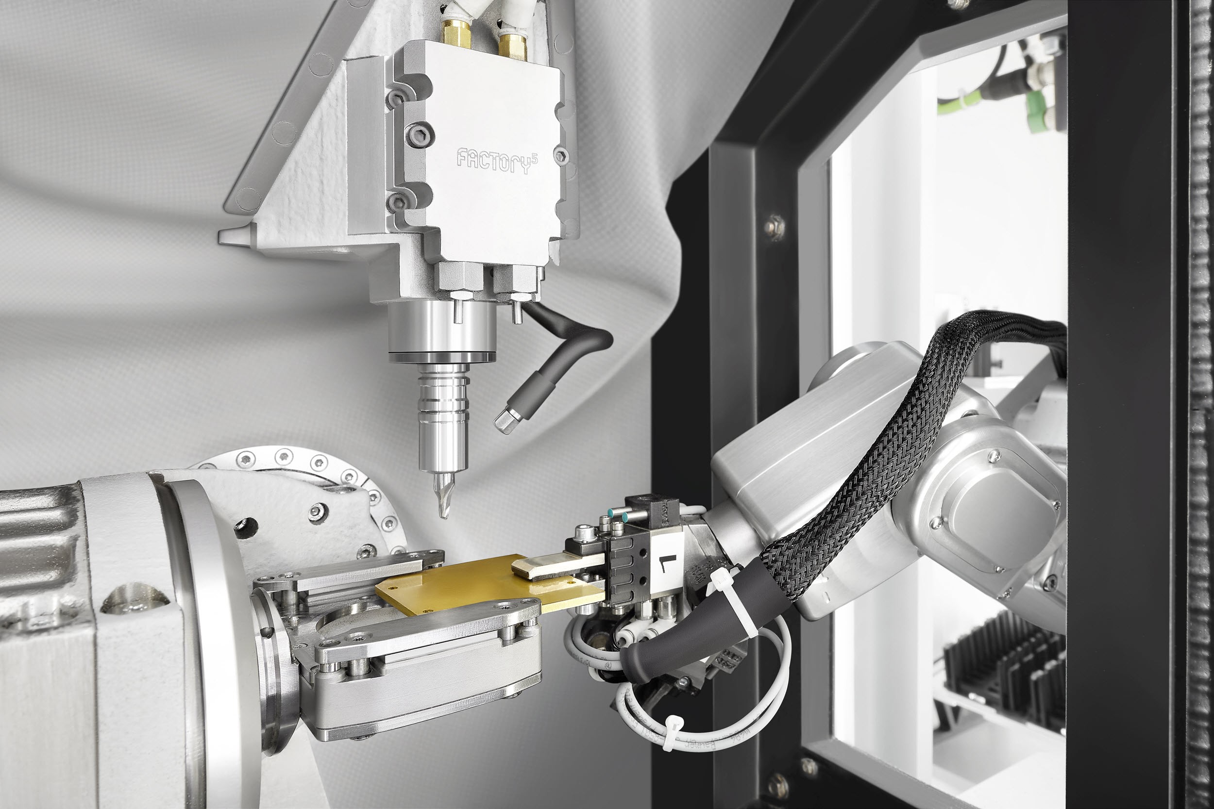 Plug-and-Play solution for automated micro machining: The Micro5, combined with the Feed5 handling system.